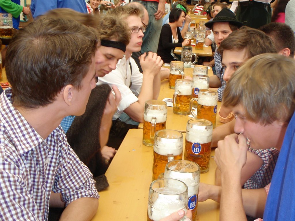 Group of men drinking liters of beer