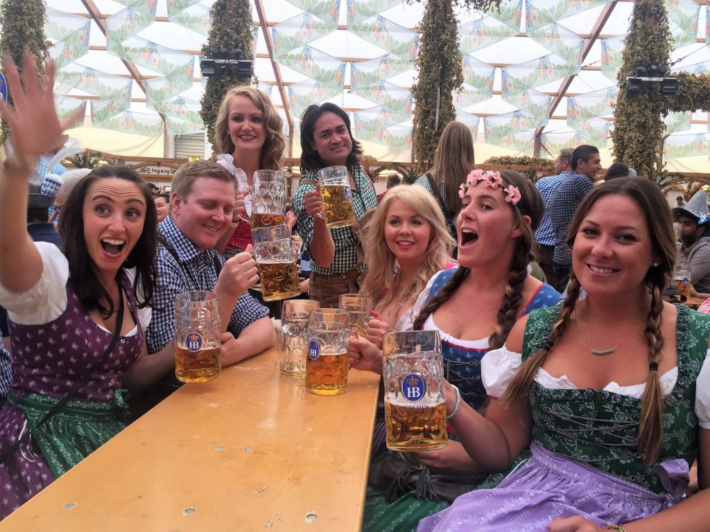 Group of men and woman drinking beer at Oktoberfest