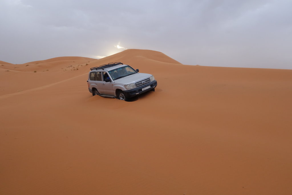 A Jeep driving through the sahara desert