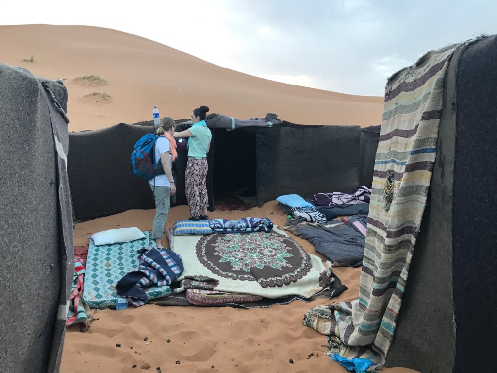 Black Tents and blankets on the foor in the desert