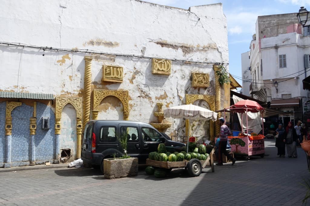 Car parked next to a watermelon cart to show you what can happen when renting a car in Morocco