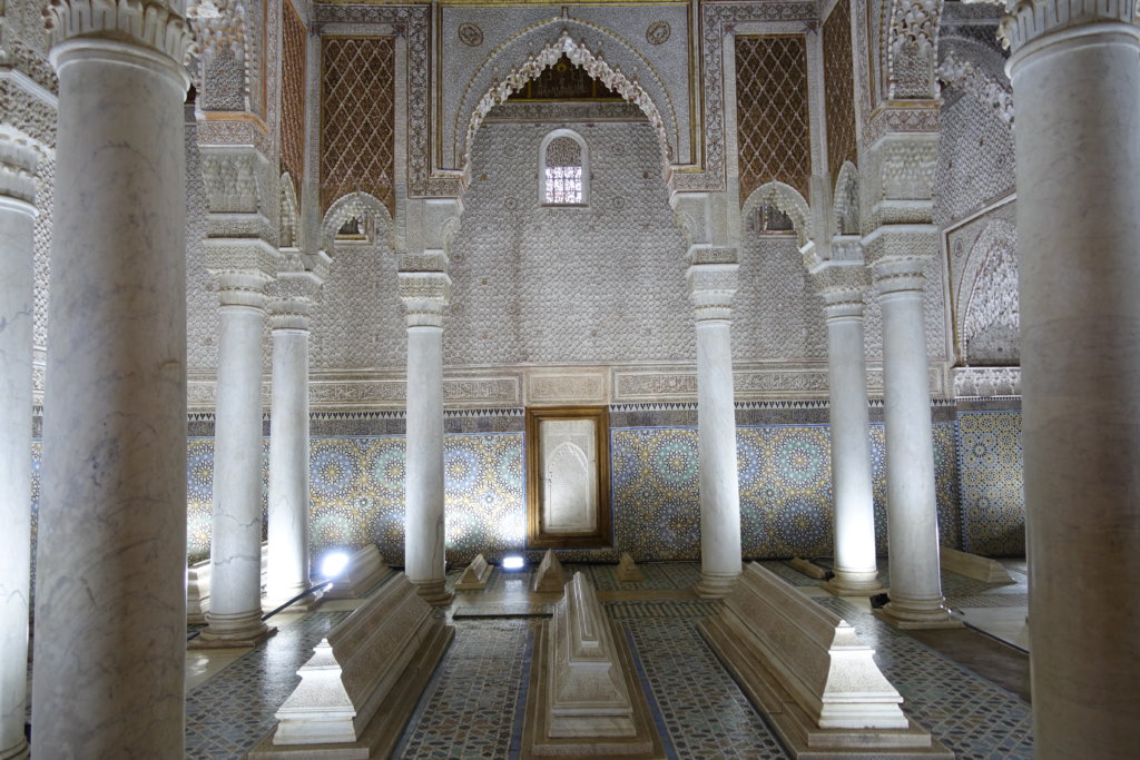 White pillars and ornate tile inside of the Saadian Tombs in Morocco 