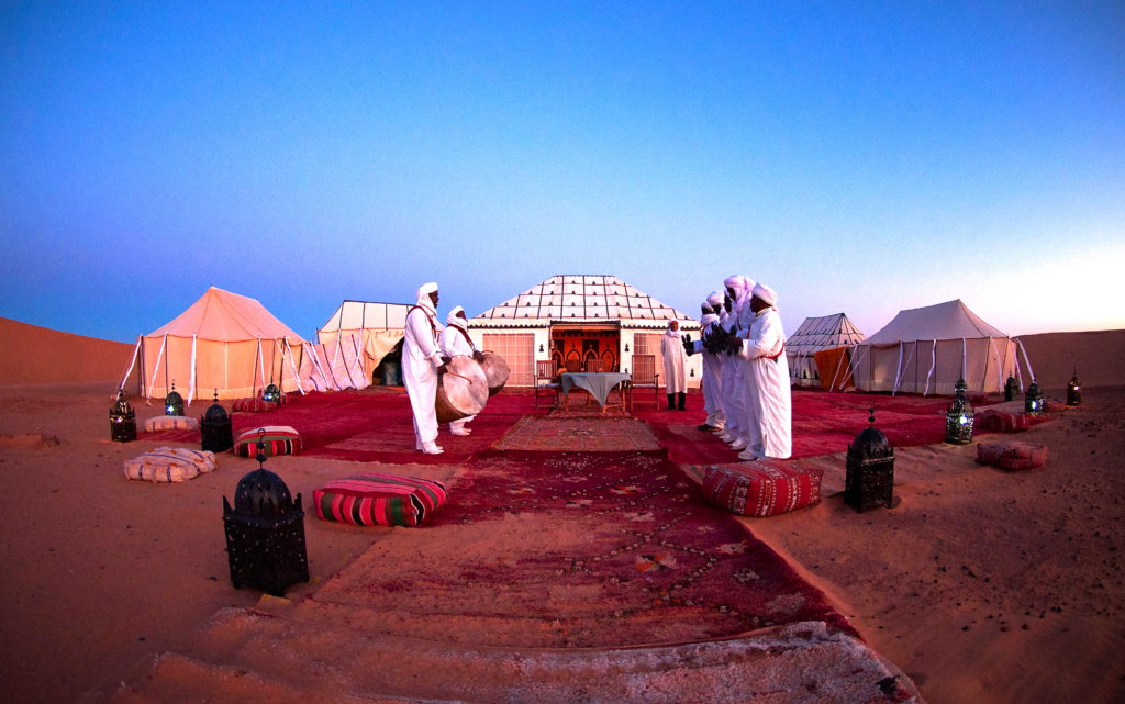 White Tents and Men holding drums in the Sahara Desert