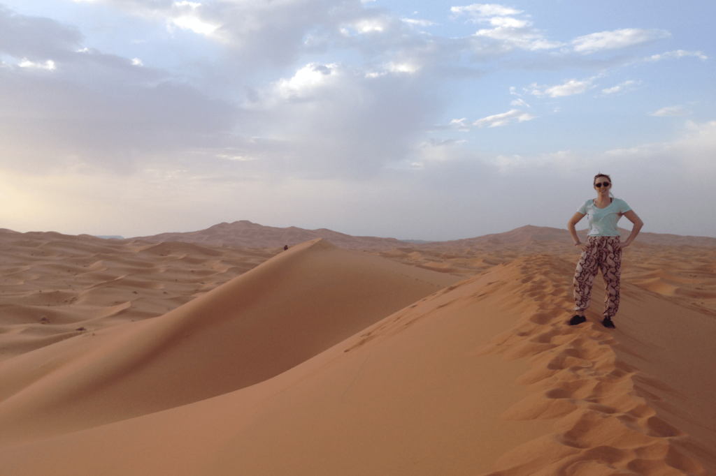 woman standing in the desert wearing haram pants 