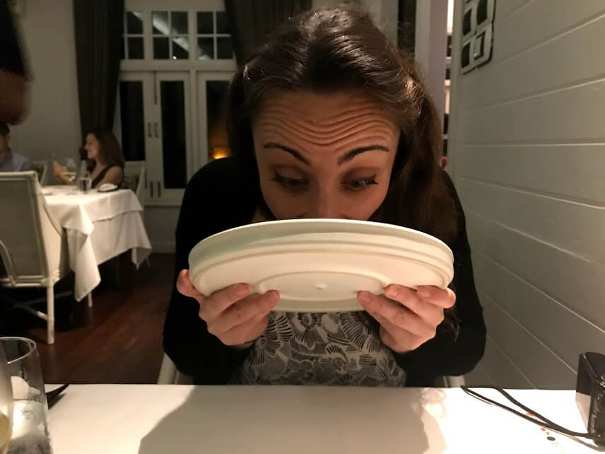 Gina licking a plate of food