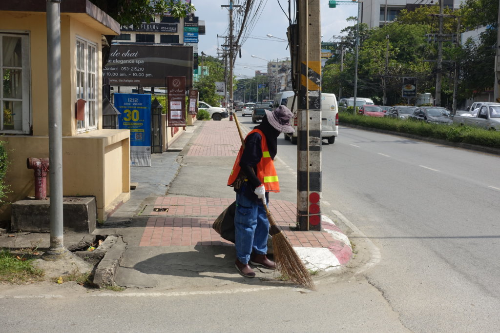 Woman Cleaning the Street
