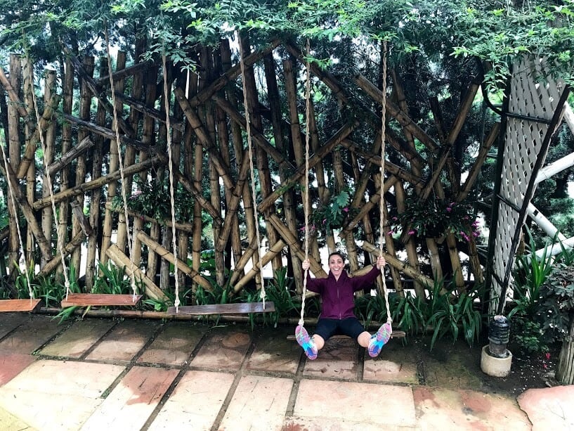 Gina on a swing in a garden