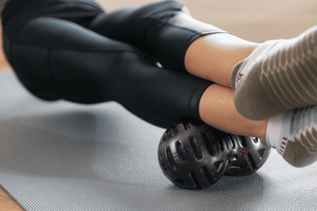 Woman using a massage ball while traveling 