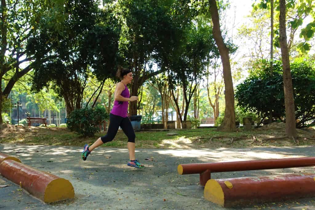 Gina running through a garden