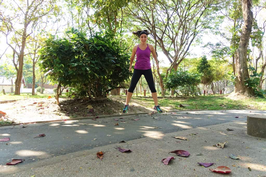 woman jumping in the air in a park 