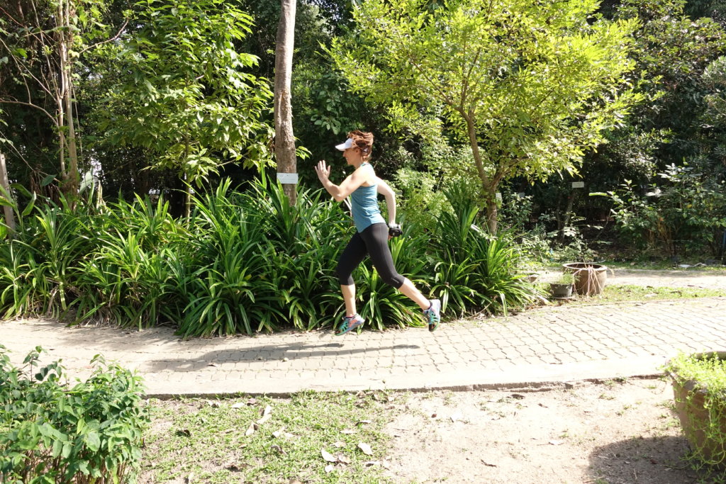 Gina running in a garden