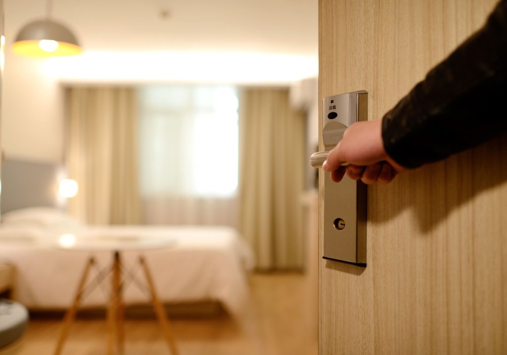 Hotel Room Door being opened to an accommodation 