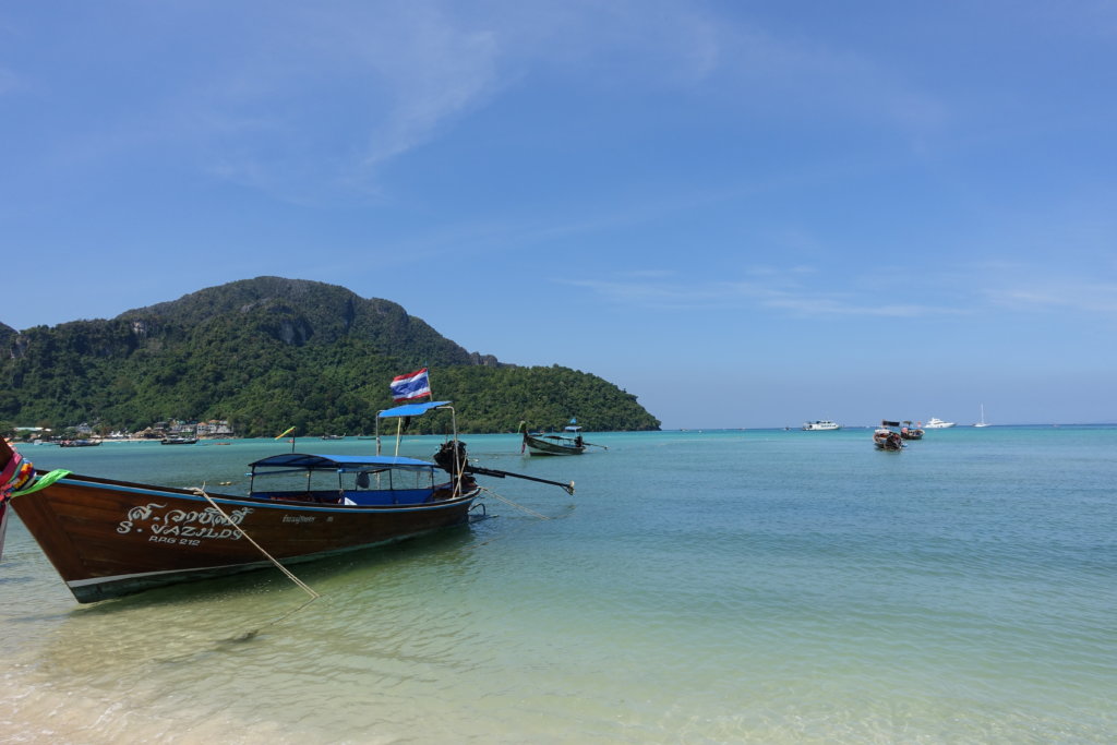 Ocean boat and rocks in Ao Nang as one of the things to do in krabi town