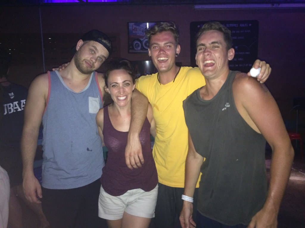 Four people smiling at a bar as one of the things to do in krabi town