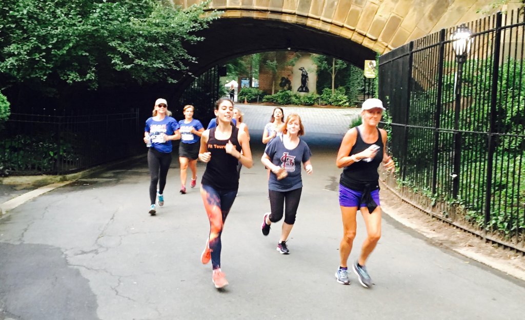 Eight people running in central park