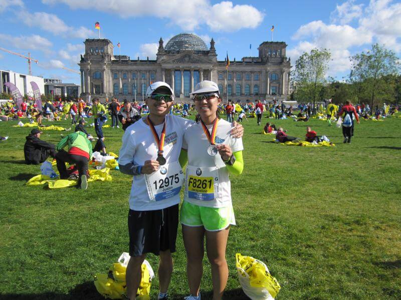 Two people after the Berlin Marathon wearing medals