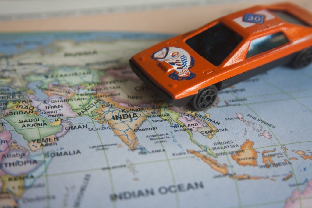 A mini toy car on top of a map