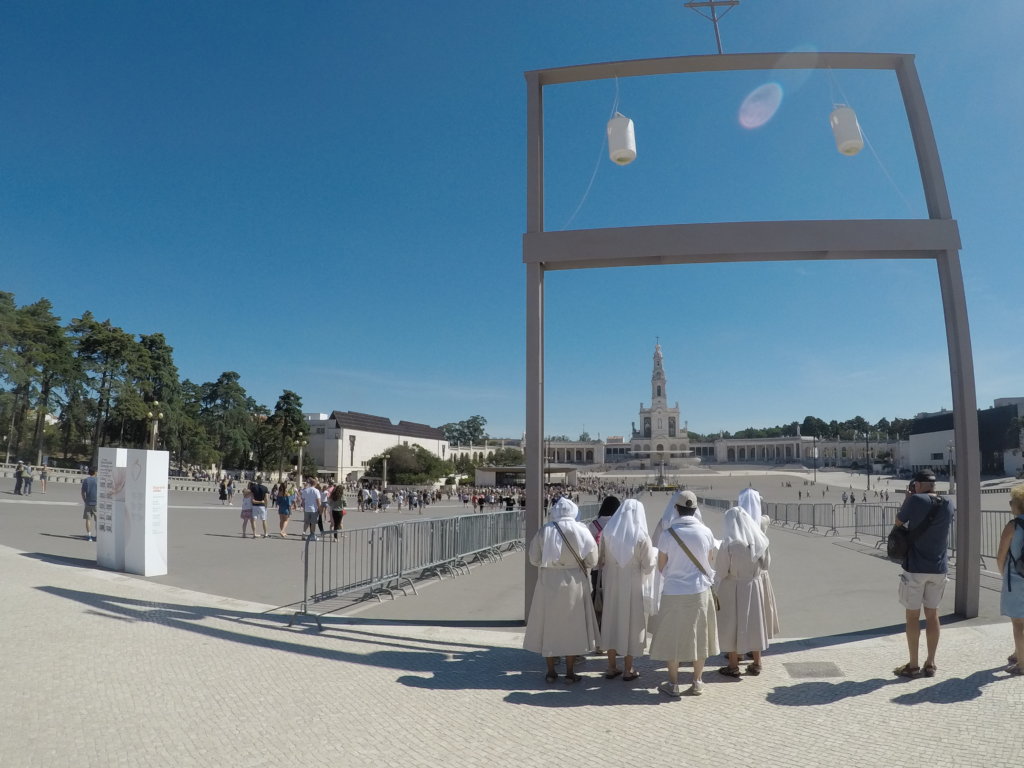 Four woman with white clothes over thier heads standing in front of a church in Fatima