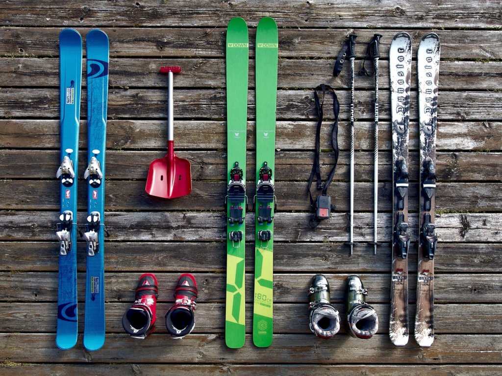 Three sets of colorful skis and poles