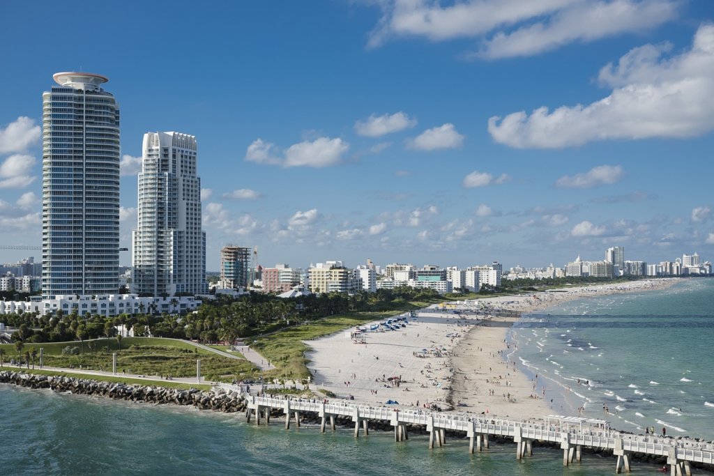 The ocean and beach in Miami with tall hotels in the background