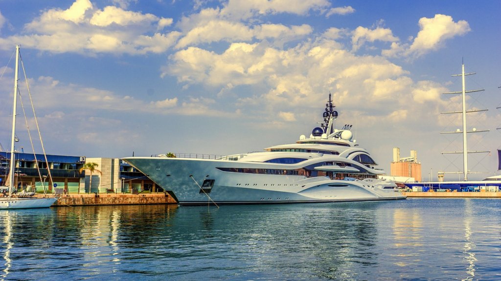 A white and blue yacht on the water 