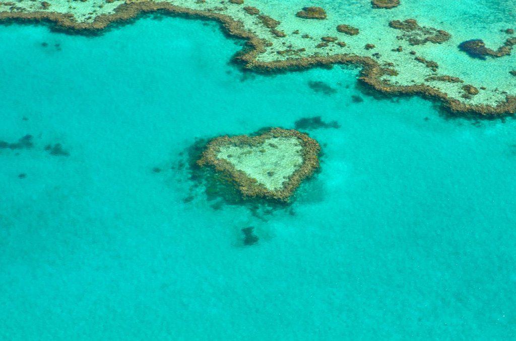 The blue ocean at the great barrier reef wit a heart shaped reef