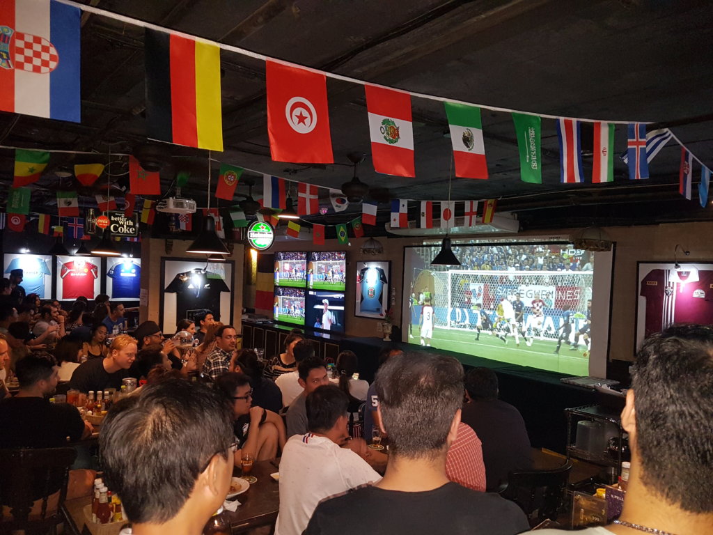 Sports bar with flags and tvs in bangkok as one of the Unique Nightlife Activities in Bangkok