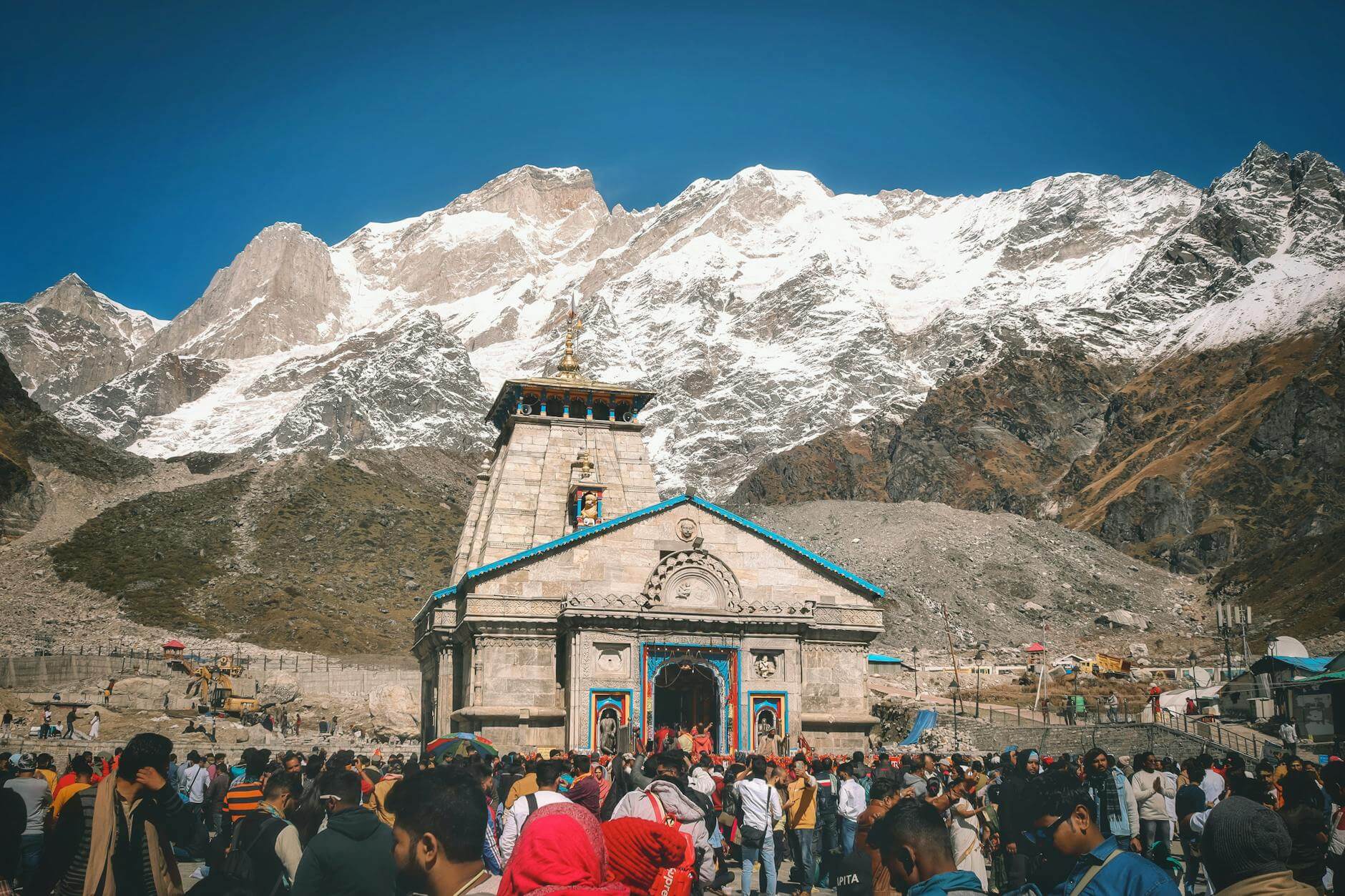 crowds of people by a mountain temple