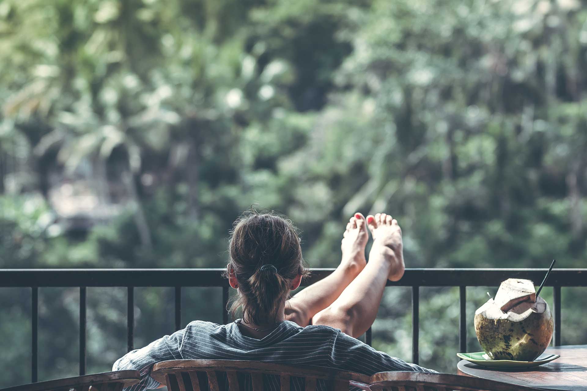 woman sitting on a balcony with her feet up