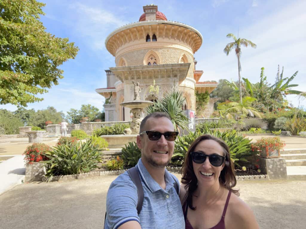 Gina and Logan in front of a cream colored mansion in Sintra Portugal