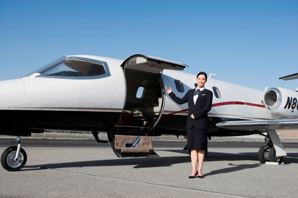 Exterior of a private jet with a woman outside one of the chartered flights