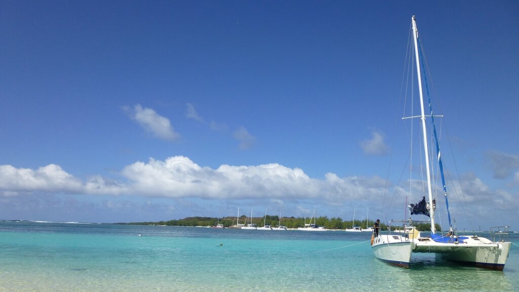 white boat in blue water in Mauritius