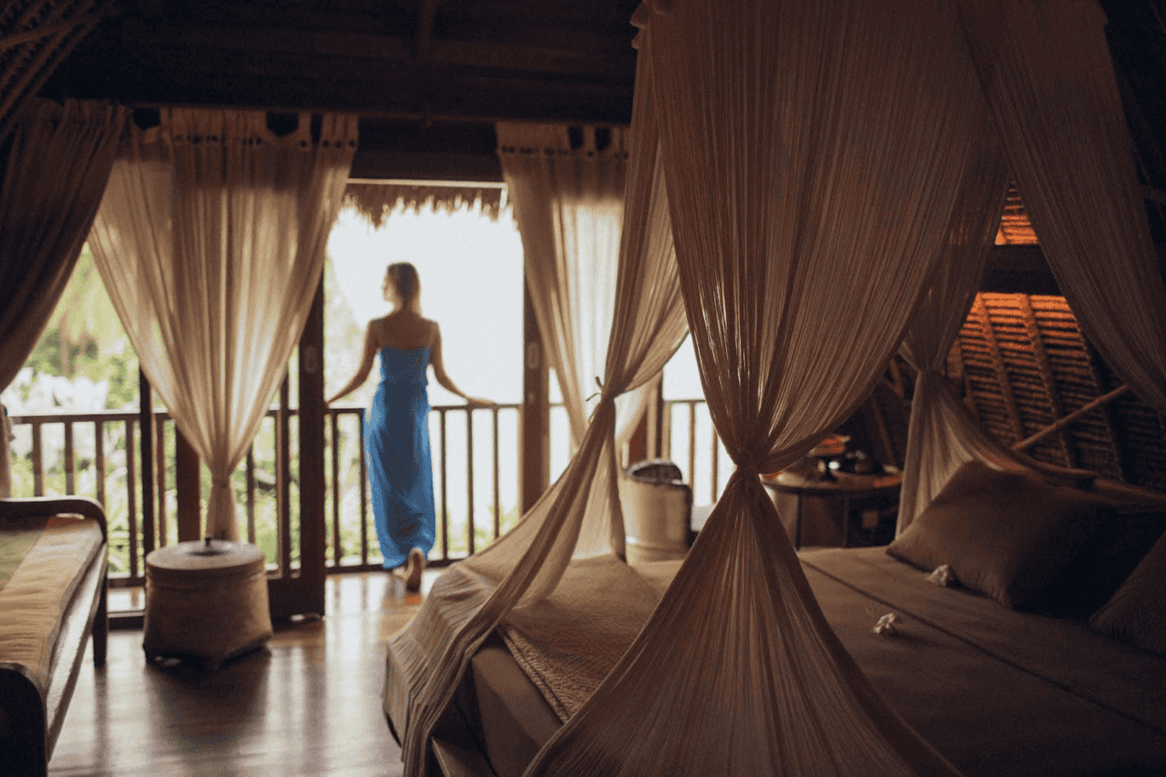 Woman standing at a balcony showing you how to have fun in a hotel