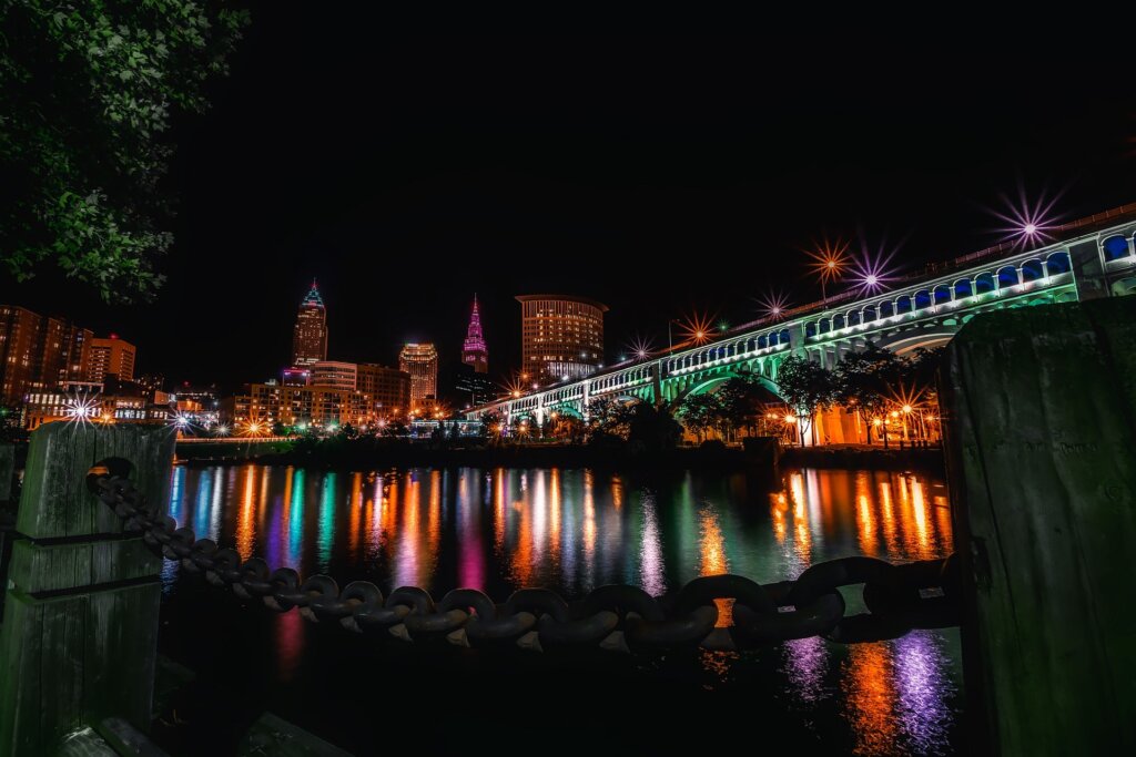Bridge and river lit up with colorful lights 