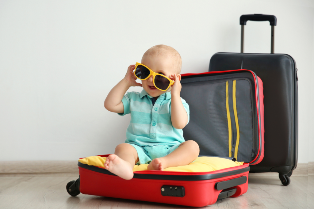 child nside of a suitcase wearing sunglasses