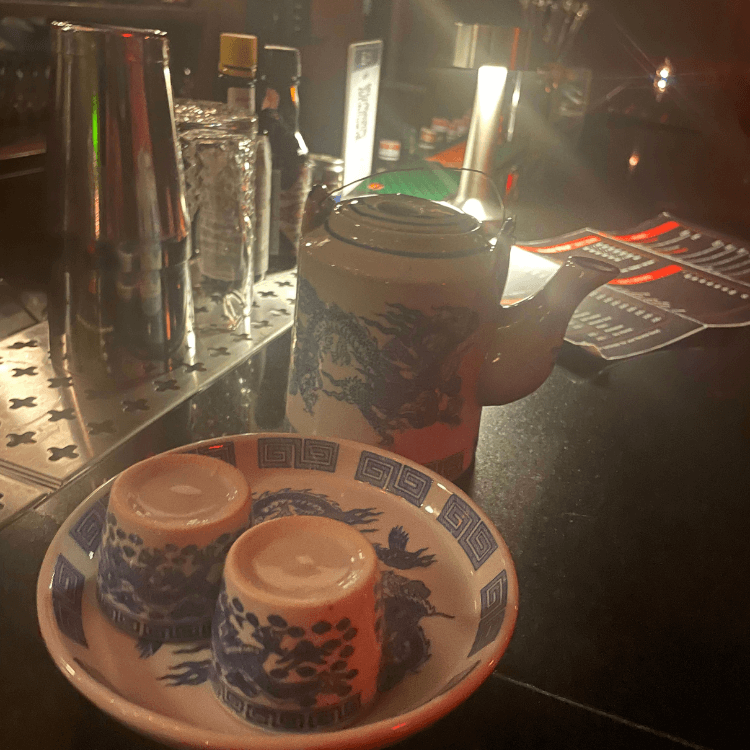 white and blue tea kettle with two tea cups at ku bar bangkok