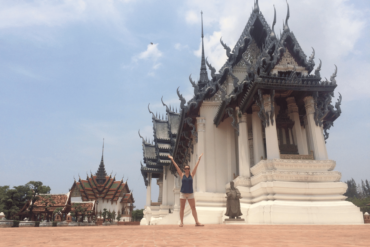 woman standing in front of a white temple in the ancient city in bangkok