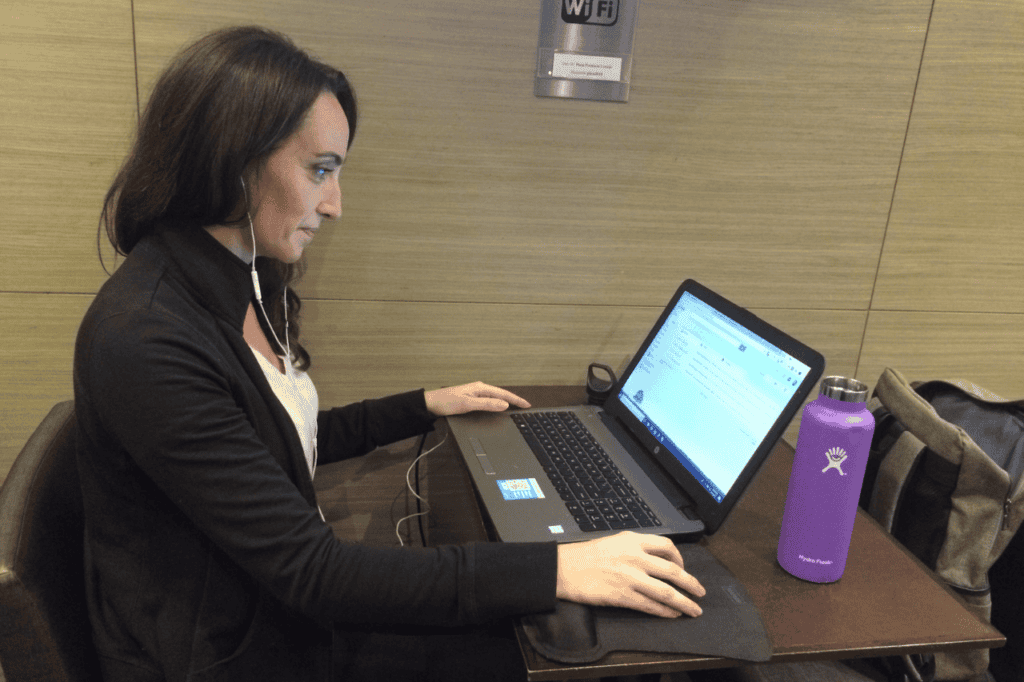 woman sitting at desk working as a digital nomad