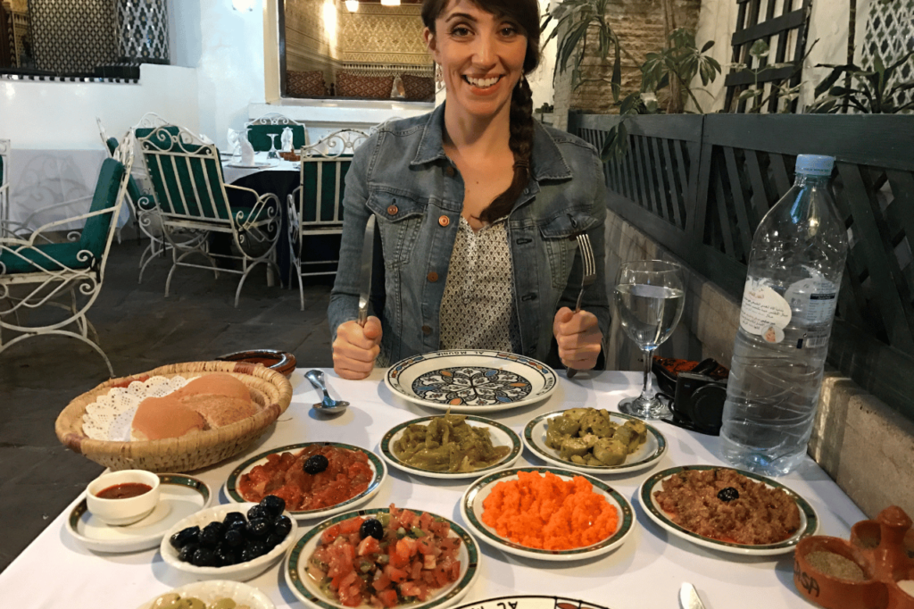 woman sitting in front of a moroccan meal