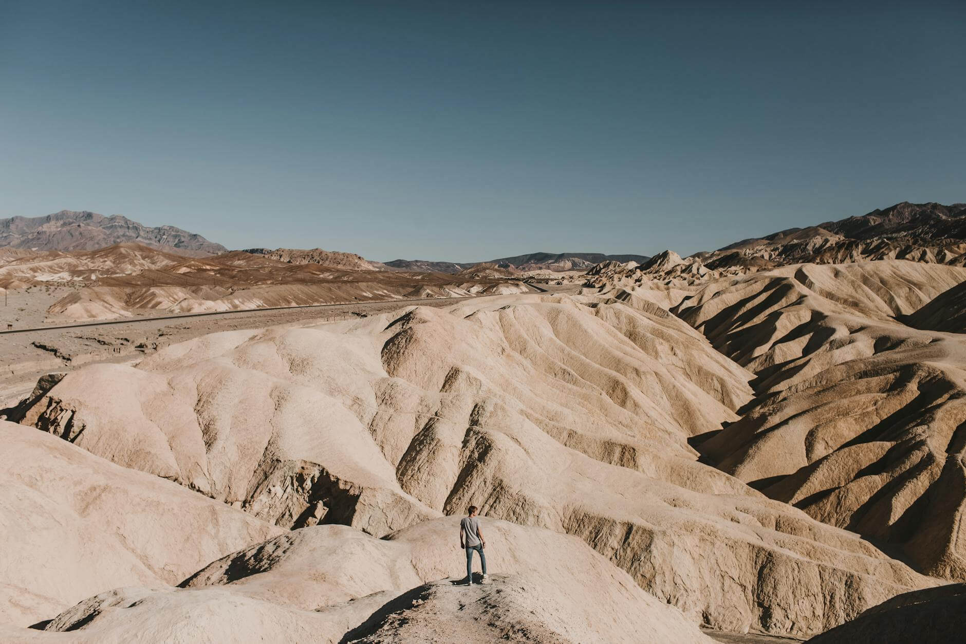 person standing on a rock mountain hiking in death valley 