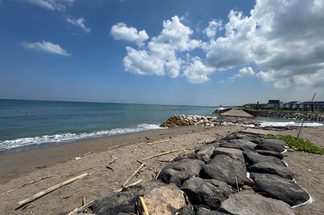 Coastal Rock Jetty at Beach in Canggu Bali Rocky jetty leading to the sea with clear skies at beach in Canggu Bali