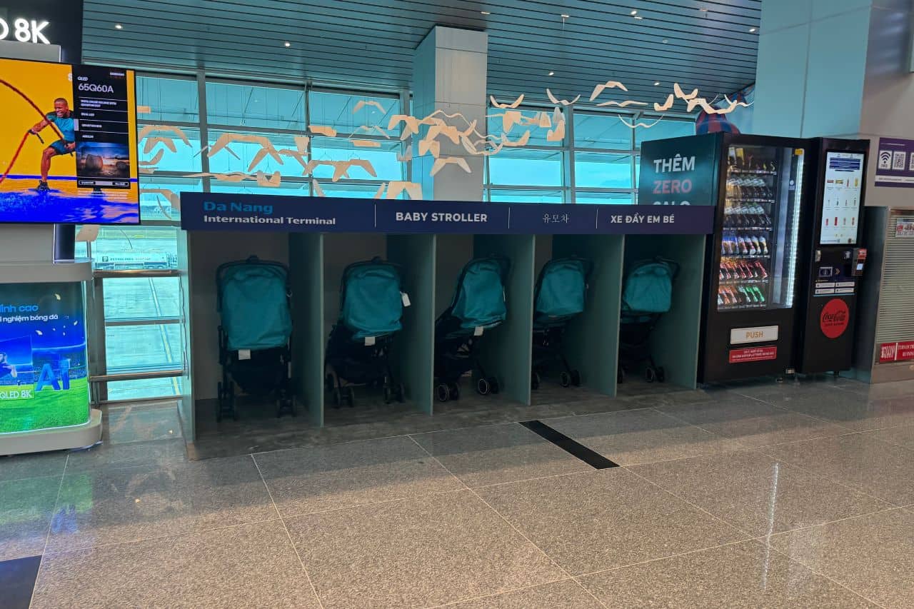 Family Services at Da Nang Airport - Baby Strollers Row of baby strollers available for passengers at Da Nang Airport, located next to vending machines in the international terminal