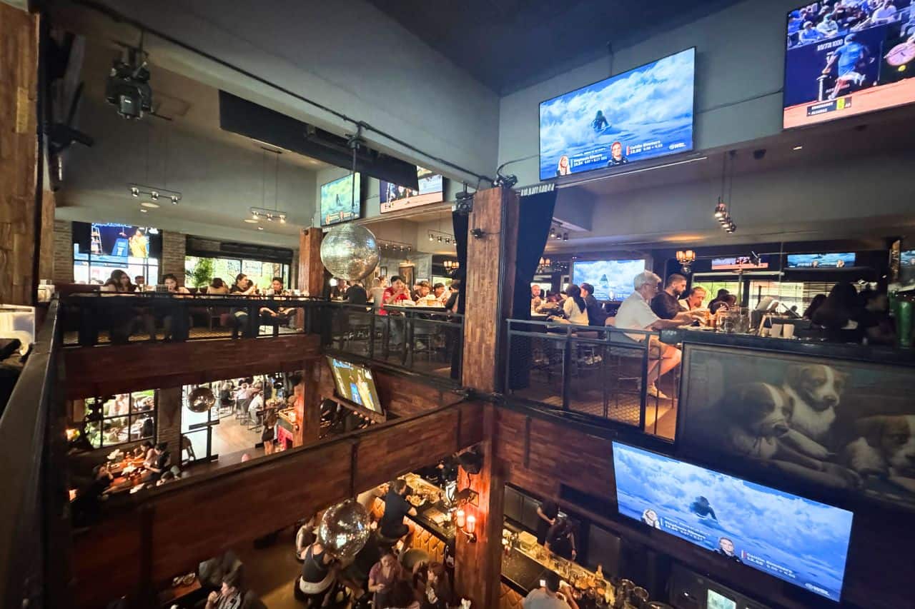Busy interior of The Forge sports bars in Canggu with multiple screens and two-story layout