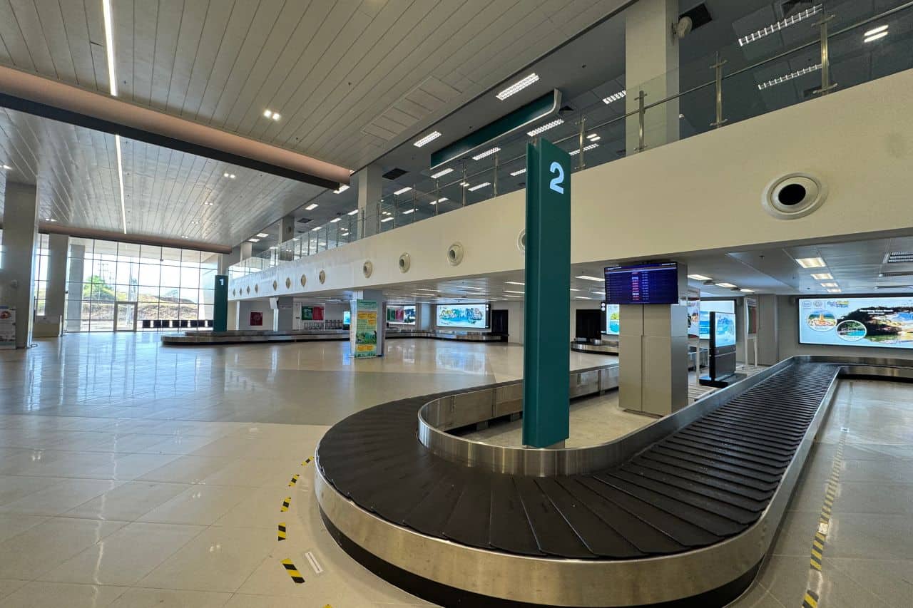 Baggage Claim Carousel - Airport at Krabi Spacious and modern baggage claim area at the airport in Krabi, Thailand, with carousel number signs and natural lighting