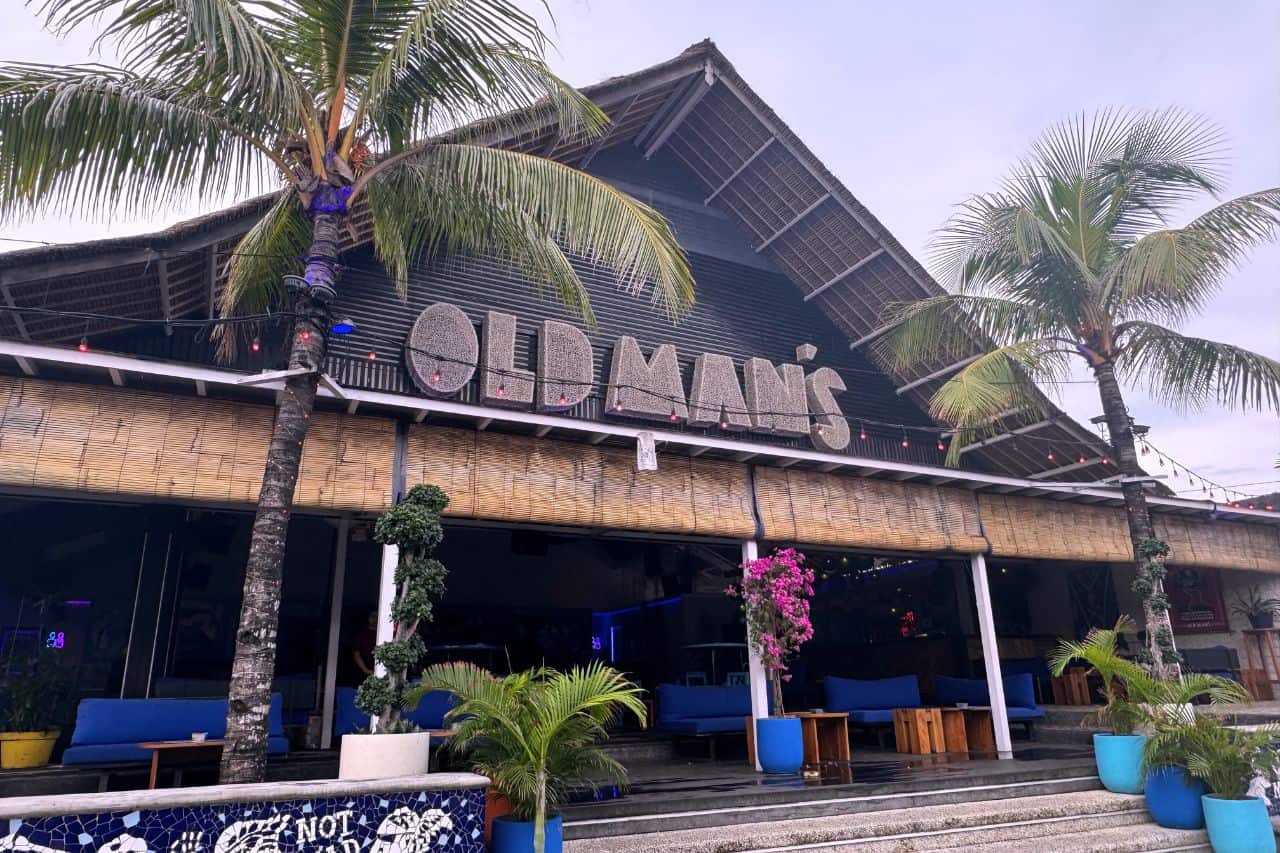 Exterior of Old Man’s bar with palm trees and beachy decor - One of the Best Bars Canggu