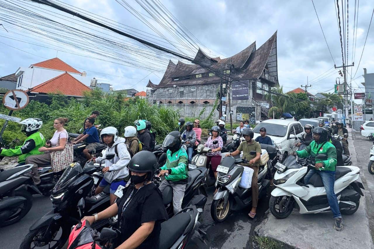 Heavy Scooter Traffic on a Street in Canggu Crowded street in Canggu with dozens of scooters and riders navigating through traffic.