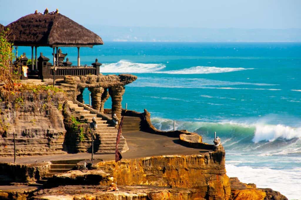 Tanah Lot Temple near Canggu Bali with ocean waves in the background, popular for sunset views and one of the only attractions in Canggu