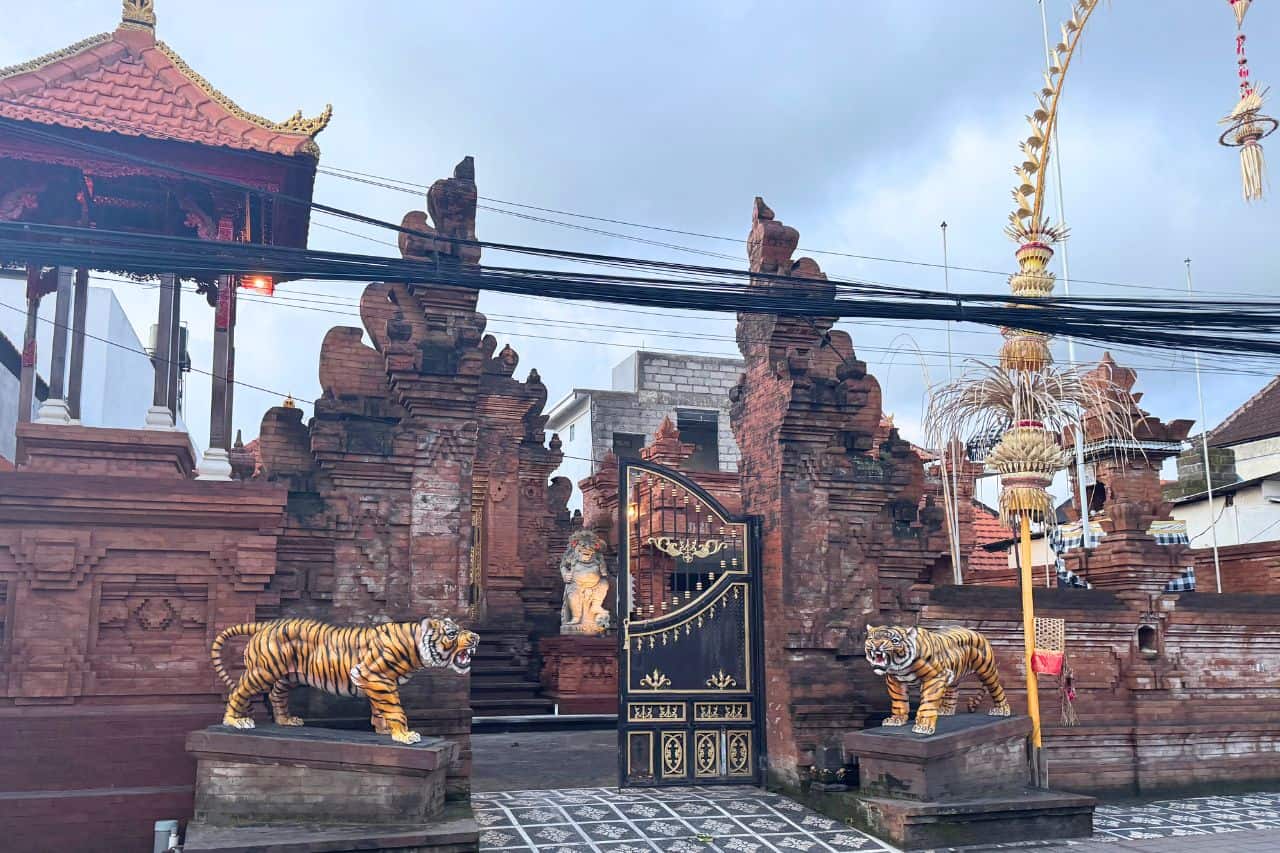 Balinese Temple Entrance Decorated with Tiger Statues in Canggu Decorative tiger statues in front of a Balinese temple entrance in Canggu Bali.