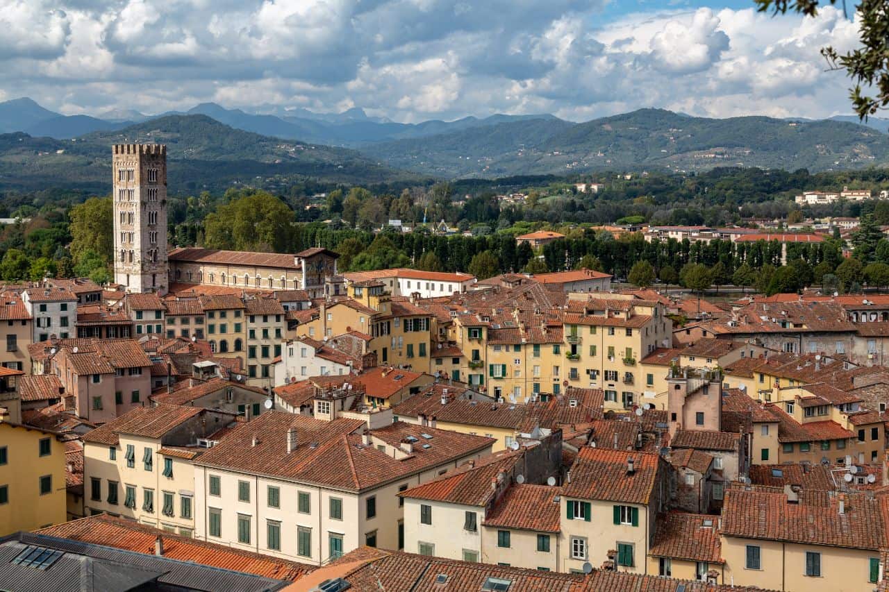 Aerial photo showing the full walled city of Lucca Italy surrounded by lush greenery and historic buildings