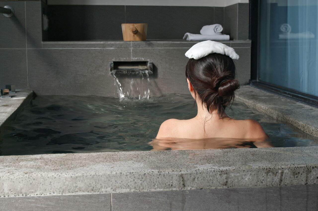 Woman enjoying a warm thermal bath at the spa in Bagni di Lucca